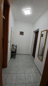 a hallway with a room with a mirror and a tile floor at Una Vibe Studio in Bosanska Krupa +1 photo