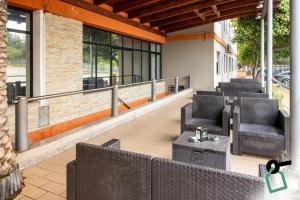 a patio with chairs and tables on a building at Hotiday Cagliari Sant'Elena in Cagliari