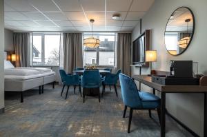 a hotel room with a bed and a table and chairs at Thon Hotel Andrikken in Andenes