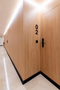 a wooden wall with the number eight on it at VORS&Co Jerez in Jerez de la Frontera
