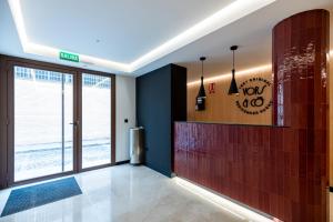 a lobby with a large glass door and a tile wall at VORS&Co Jerez in Jerez de la Frontera