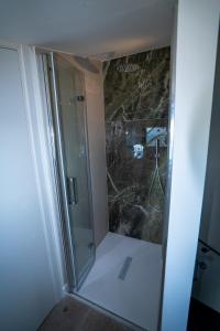 a shower with a glass door in a bathroom at Lagò-Anguillara Sabazia in Anguillara Sabazia