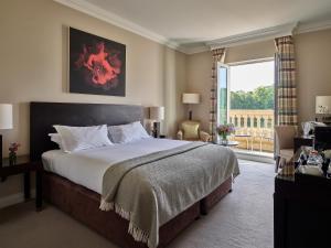 a bedroom with a large bed and a large window at Bowood Hotel, Spa, and Golf Resort in Chippenham +51 photos