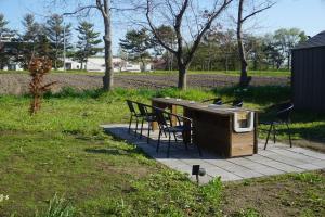 a wooden table and chairs on a patio at Kaede Lakehouse Toya in Lake Toya