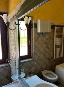 a bathroom with a sink and a toilet and a window at Tenuta Ciaramiti Luxury Garden & Pool in Brattirò +17 photos