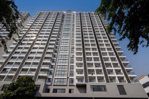 a tall white building with many windows at Mecon Hotel in Phnom Penh