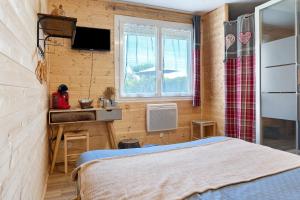 a bedroom with a bed and a sink and a window at Chambres d'Emilie - Table d'Hôte in Lau-Balagnas