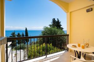a balcony with a table and a view of the ocean at Siora Leni Hotel in Benitses +37 photos
