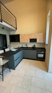 a kitchen with a black counter top and a stove at La Torre di LuSi in Castellammare di Stabia