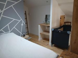 a bedroom with a bed and a desk in it at Gite de Labarraque in Monbahus