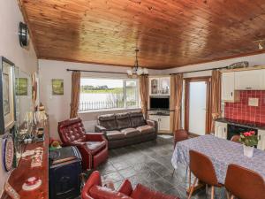 a living room with a table and a couch at Sweetbriar Lodge in Castlerea