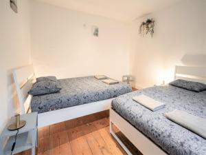 a room with two beds and a table in it at Deluxe Capital Street Stay for 12 in Antwerp