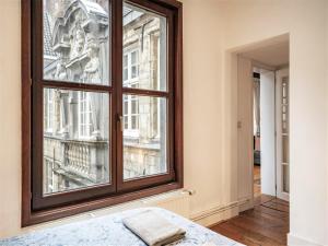 a bedroom with a window with a view of a city at Deluxe Capital Street Stay for 12 in Antwerp +38 photos