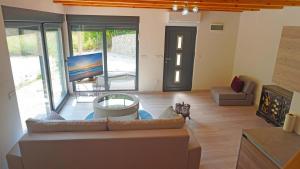 a living room with a couch and a tv at Zora - moje mjesto in Konjic