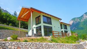 a house on a hill with mountains in the background at Zora - moje mjesto in Konjic