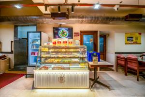 a display case in a restaurant with food on display at Hotel Surguru in Pondicherry