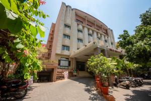 a building with motorcycles parked in front of it at Hotel Surguru in Pondicherry