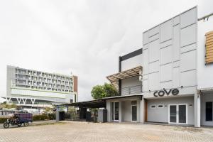 a building with a motorcycle parked in front of it at Cove Anasera in Jombang