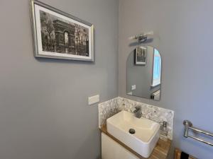 a bathroom with a sink and a mirror at Swan Lodge in Swanage