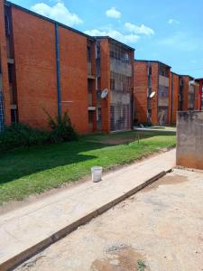 a brick building with a bucket in front of it at Apartment 8, 7373A, Mtedza Rd in Lusaka
