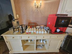 a counter with a coffee maker on top of it at Hotel Pension Museum in Vienna