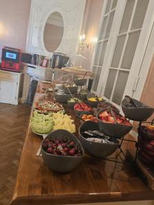 a table filled with bowls of different types of food at Hotel Pension Museum in Vienna