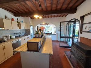 a kitchen with a large island in a room at Azalea Guest House in Siena