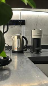 a coffee pot sitting on top of a kitchen counter at M Residence in Dhahran