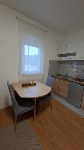 a kitchen with a table and chairs in a room at Una Vibe Studio in Bosanska Krupa