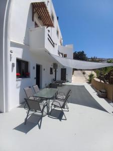 a patio with a table and chairs on a building at Velania House 1 in Filótion