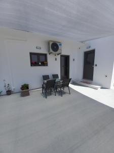 a room with chairs and a table and a fan at Velania House 1 in Filótion +23 photos