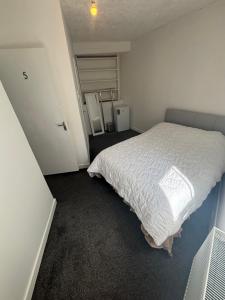 a bedroom with a bed with a white comforter at Kinsale central 5 in Kinsale