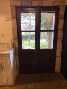 a wooden door with a window in a room at Fiorire Casale Olistico in Attigliano +26 photos