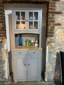 a large white cabinet in a corner of a room at Fiorire Casale Olistico in Attigliano