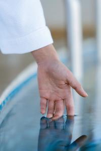 a person with their hand on a table at Mandala Hotel & Suites Hải Dương in Bảo Thap