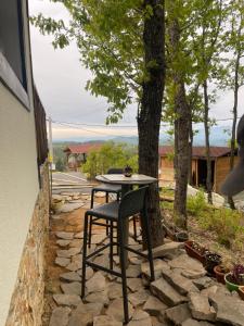 a table and chair sitting on a stone patio at Villa Elias in Zlatograd