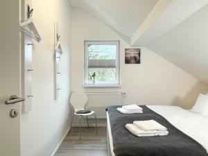 a small bedroom with a bed and a window at Fewo Diemelsee 5 in Heringhausen