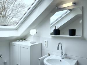 a bathroom with a sink and a skylight at Fewo Diemelsee 5 in Heringhausen +21 photos