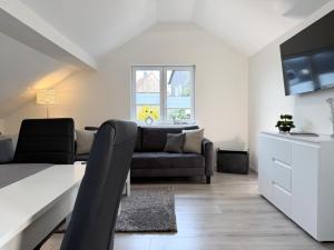 a living room with a couch and a table at Fewo Diemelsee 5 in Heringhausen