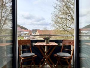 a table and two chairs on a balcony with a view at Fewo Diemelsee 4 in Heringhausen