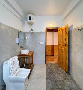 a bathroom with a toilet and a sink at Chhaon Stays in Shoja +42 photos