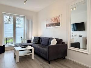 a living room with a couch and a table at Fewo Diemelsee 1 in Heringhausen