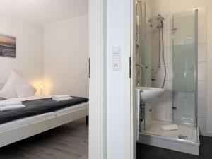 a bathroom with a bed and a shower and a sink at Fewo Diemelsee 1 in Heringhausen +11 photos