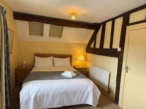 a bedroom with a bed with towels on it at Yesterday's Guest House in Newtown