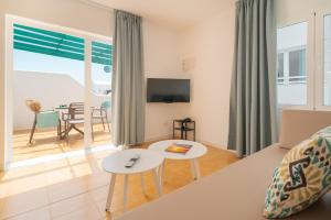 a living room with a couch and a table at Apartamentos Celeste in Costa Teguise