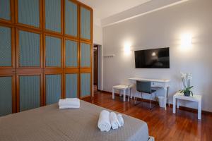 a bedroom with a bed and a desk and a table at Room & Breakfast D'Annunzio in Ravenna +47 photos