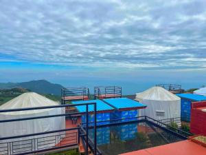 a group of tents with the ocean in the background at วิวดีภูทับเบิก in Ban Maeo Thap Boek