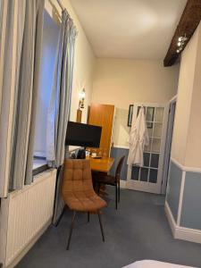 a dining room with a table and a chair at Yesterday's Guest House in Newtown +2 photos