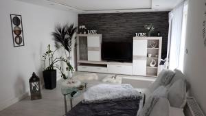 a living room with a couch and a tv at Ferienwohnung in Naila in Naila