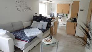 a living room with a couch and a kitchen at Ferienwohnung in Naila in Naila